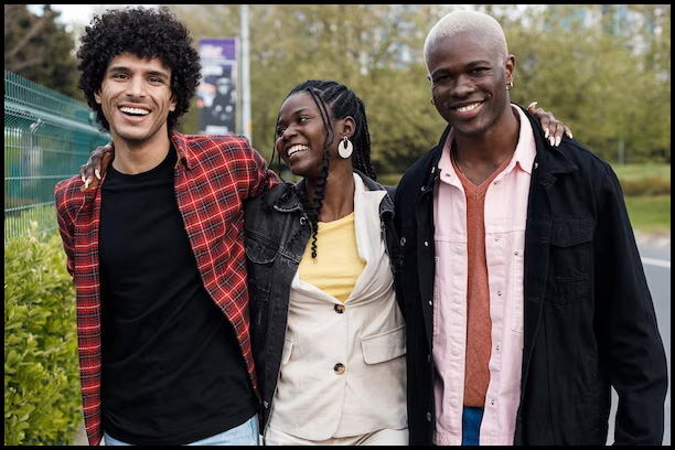 Photo of three Afrodescendants smiling and walking together
